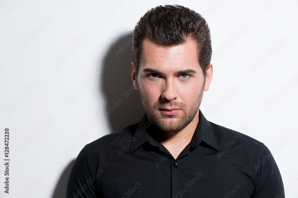 Portrait of young man in black shirt. Portrait of young man in black shirt.