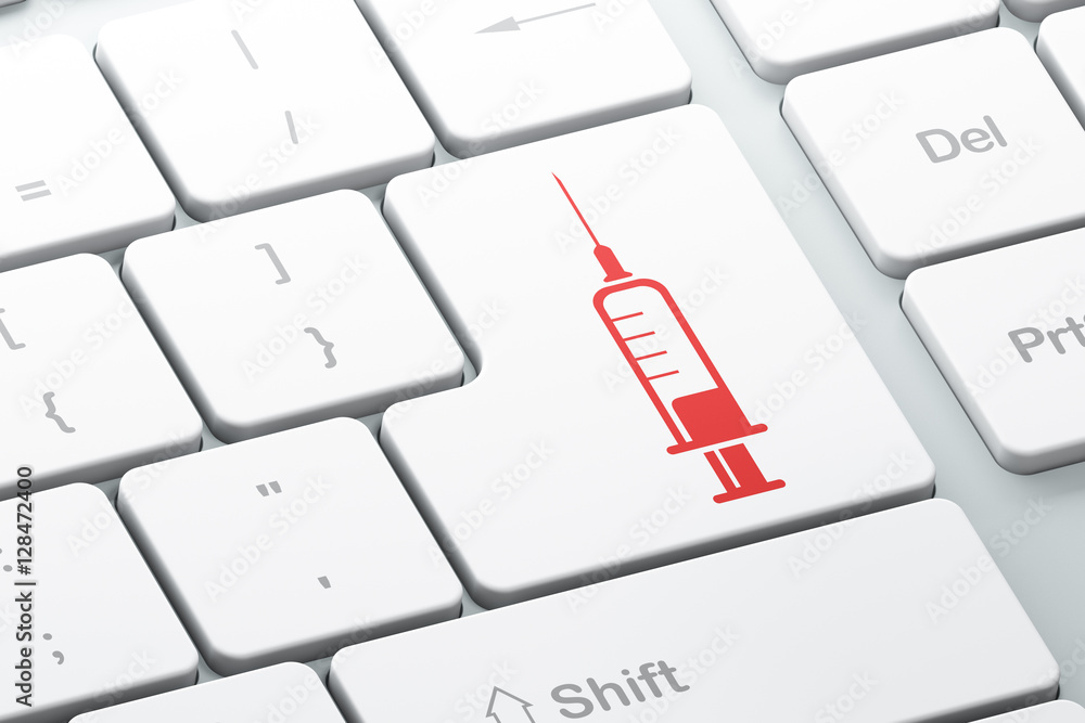 Health concept: Syringe on computer keyboard background Health concept: Syringe on computer keyboard background