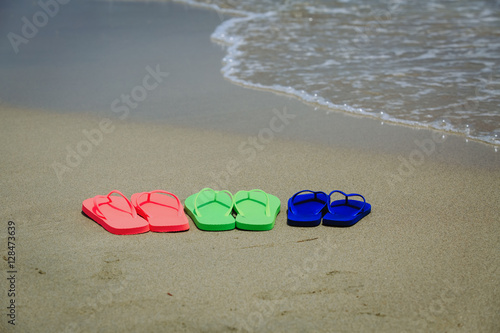 Fototapeta Naklejka Na Ścianę i Meble -  family beach flip flops at sea