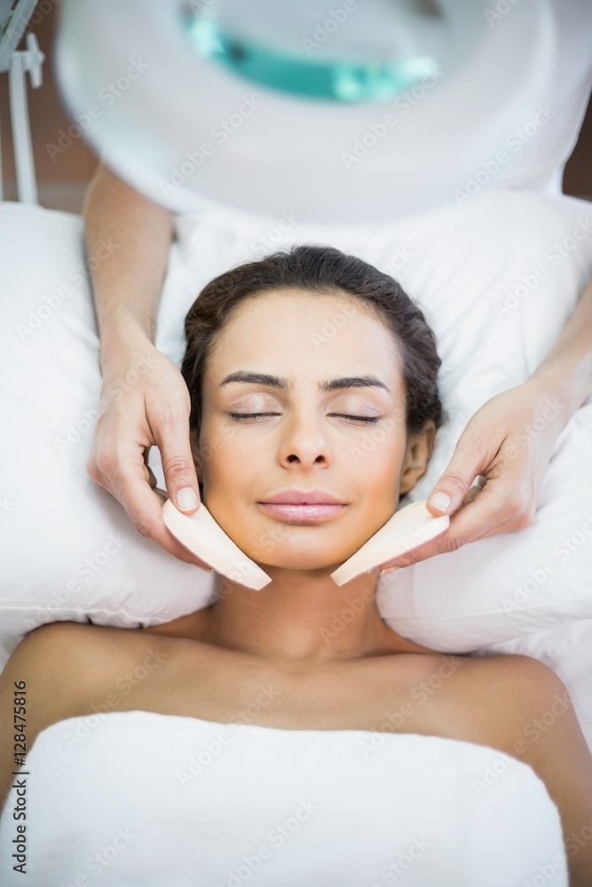 Close-up of woman receiving facial massage Close-up of woman receiving facial massage
