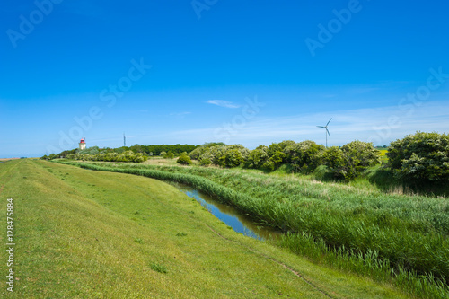 Hochwasserdeich mit Leuchtturm bei Westermarkelsdorf photo