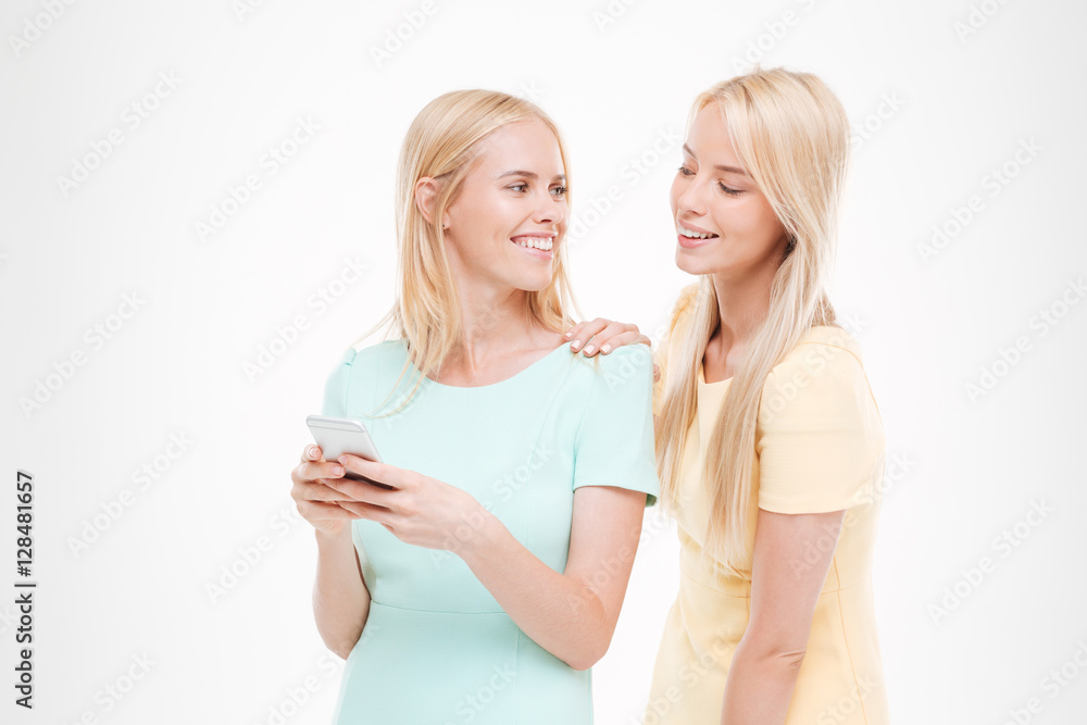 Young attractive lady showing her phone to the friend Young attractive lady showing her phone to the friend