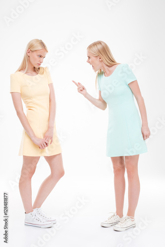 Two girlfriends swear over white background