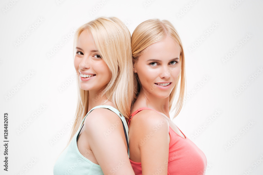 Two young cheerful women dressed in t-shirts Two young cheerful women dressed in t-shirts