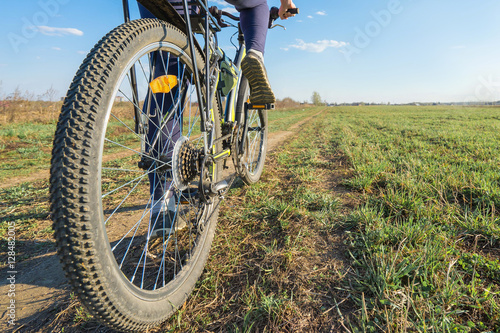 Woman riding on bike on nature. Close up shot. Selective focus.