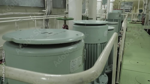 Electric motors on pumps of cooling system in engine room of ship