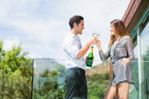 Couple toasting champagne at balcony © WavebreakmediaMicro