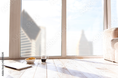 Healthy breakfast and computer on flooring at home