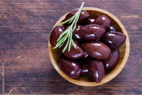 red kalamata olives on a wooden table photo