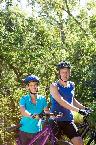 Senior couple standing with their bikes