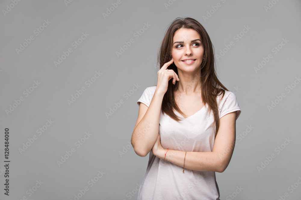 Portrait of beautiful brunette woman with natural make-up, on grey background Portrait of beautiful brunette woman with natural make-up, on grey background