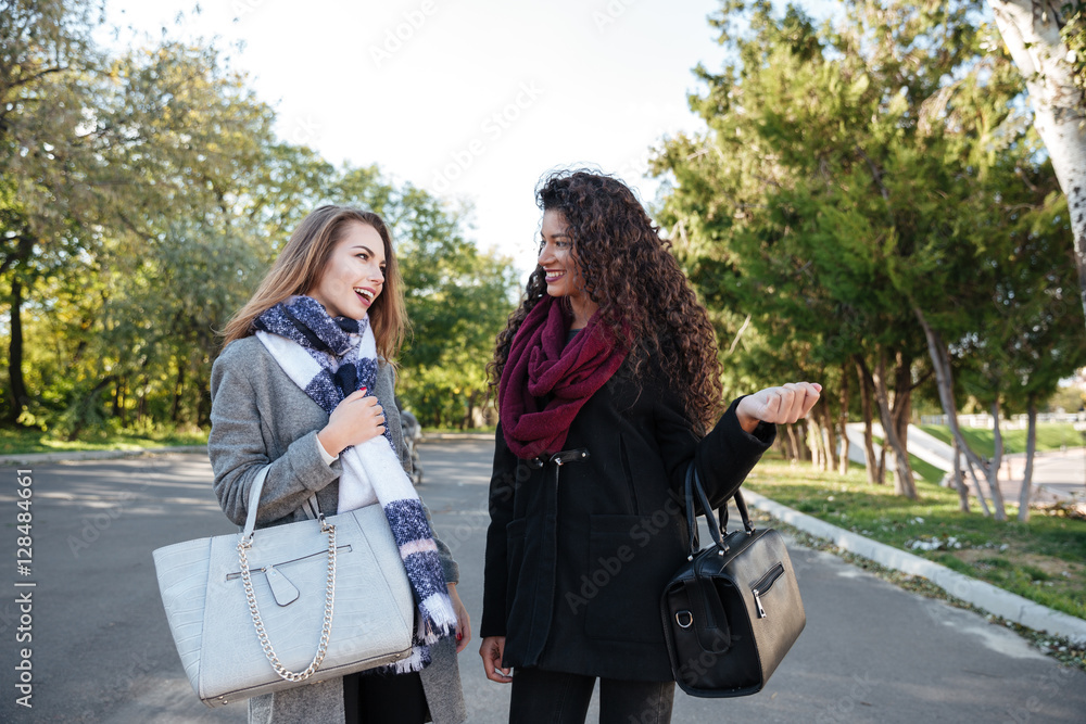 Two beautiful ladies wearing scarfs communication Two beautiful ladies wearing scarfs communication