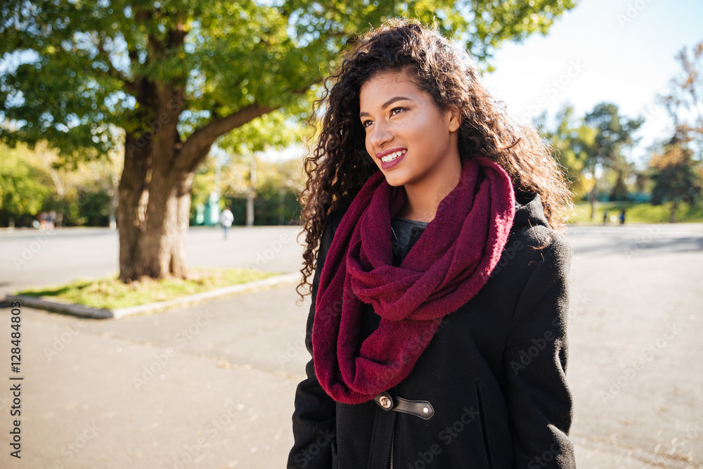 Cheerful young dark skinned curly woman wearing scarf Cheerful young dark skinned curly woman wearing scarf