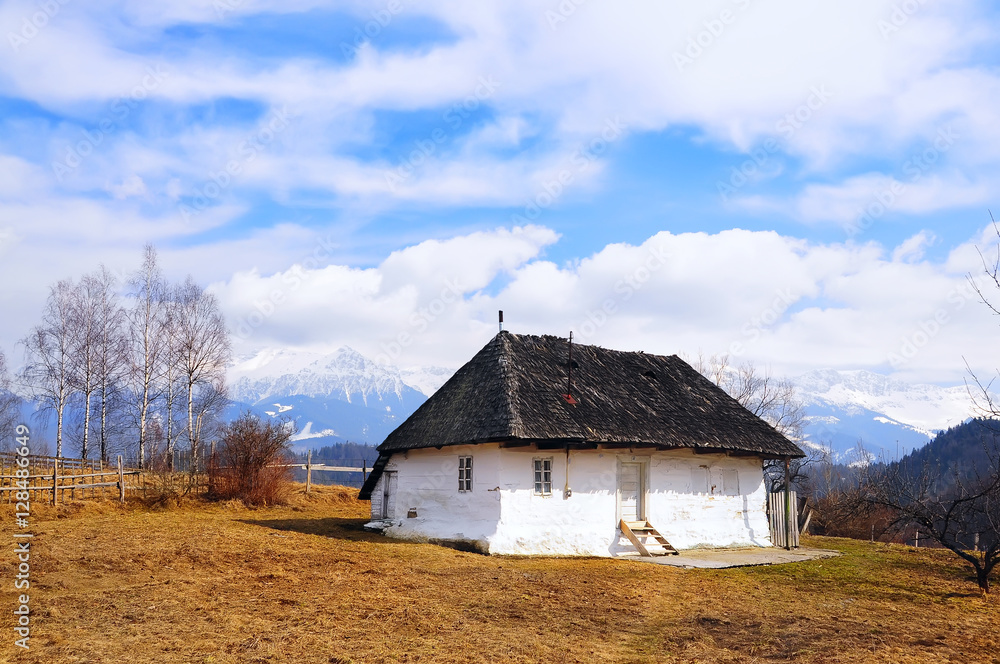 small simple white wooden rural old house with a thatched roof on a background of snow-capped mountains. Beautiful winter desert landscape.
small simple white wooden rural old house with a thatched roof on a background of snow-capped mountains. Beautiful winter desert landscape.