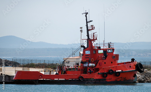 Red tugboat in the port.