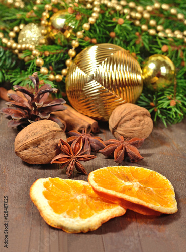Different kinds of spices, nuts, cone and dried oranges, Christm