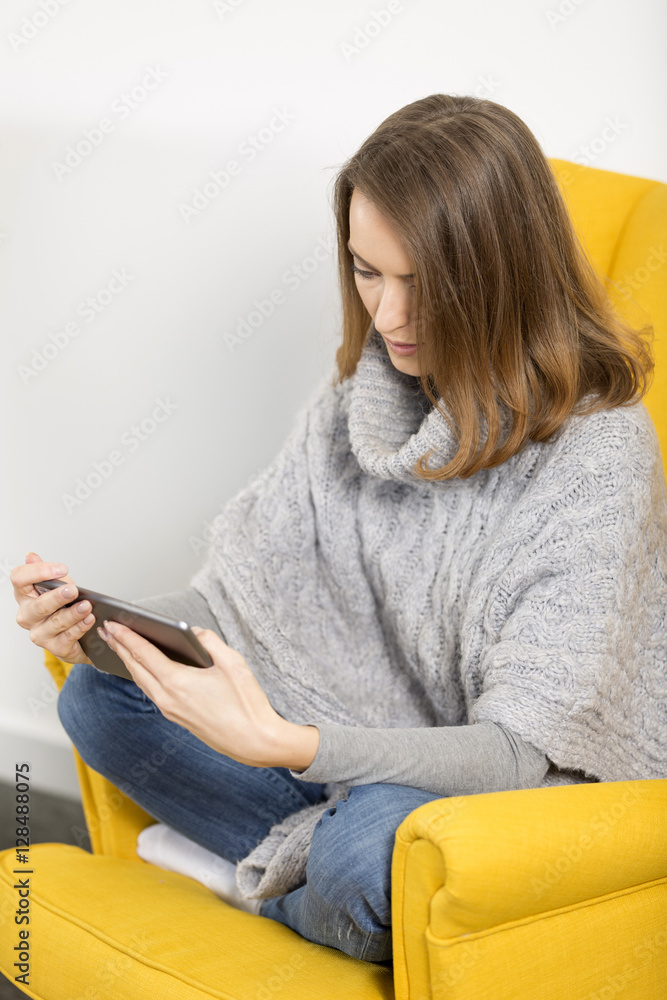Young woman using her tablet computer Young woman using her tablet computer