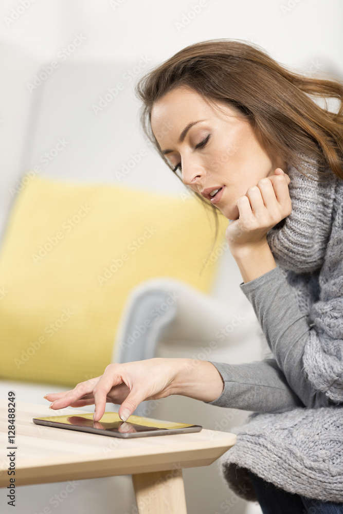Young woman using her tablet computer Young woman using her tablet computer
