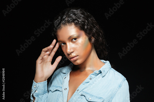 Beautiful african american young woman with stylish makeup standing