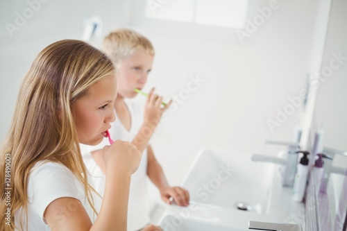 Boy and girl brushing teeth
