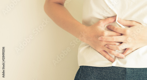 woman stomach ache because of gastritis or menstruation and dige