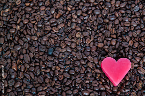 Red soap heart on coffee beans