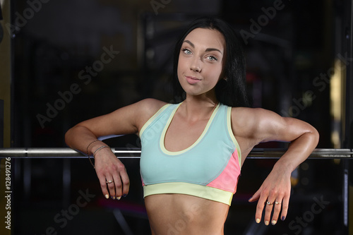 Athletic young woman posing and doing fitness workout with weigh