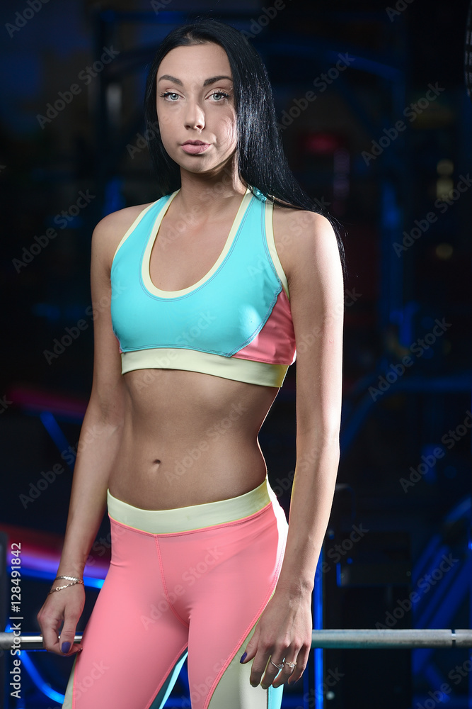 Athletic young woman posing and doing fitness workout with weigh Athletic young woman posing and doing fitness workout with weigh