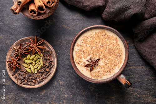 Fotografie Masala tea chai latte traditional hot Indian sweet milk spiced drink, ginger, ci