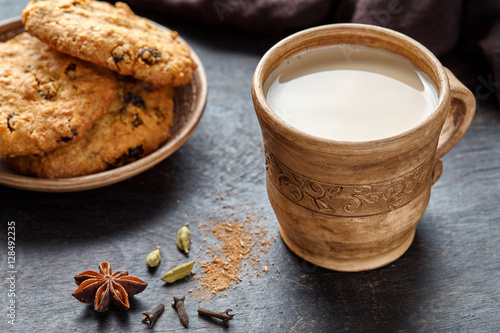 Fototapeta Naklejka Na Ścianę i Meble -  Milk tea chai latte traditional homemade refreshing morning breakfast organic healthy hot beverage drink with natural aroma spices blend, cardamon, anise, cinnamon, in rustic ceramic cup on