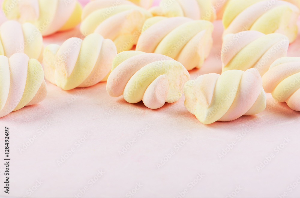 many sweets marshmallow on a pink background horizontal