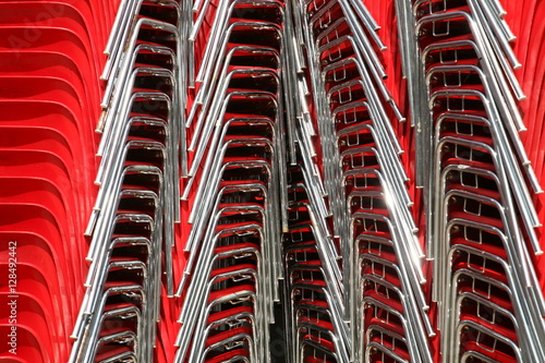 red chairs stacked © belleepok