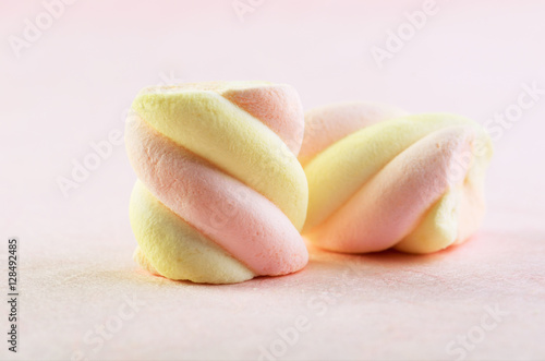 two sweets marshmallow on a pink background horizontal
