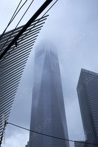 NEW YORK CITY - SEPTEMBER 30, 2016: One World Trade Center shrouded in fog next to the Transportation Hub by Calatravas photo