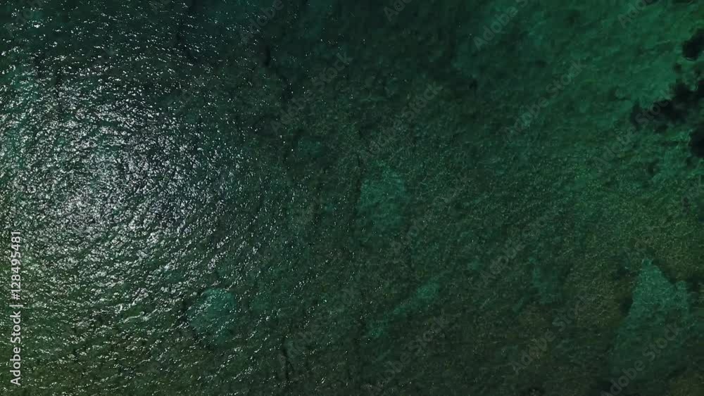 Aerial of beautiful clear green sea surface with camera rising. Aerial of beautiful clear green sea surface with camera rising.