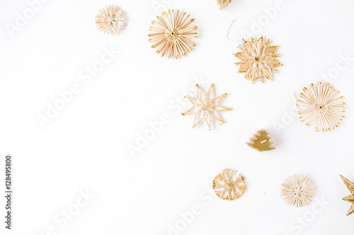 creative arrangement of bright straw christmas toys on white background. flat lay, top view
