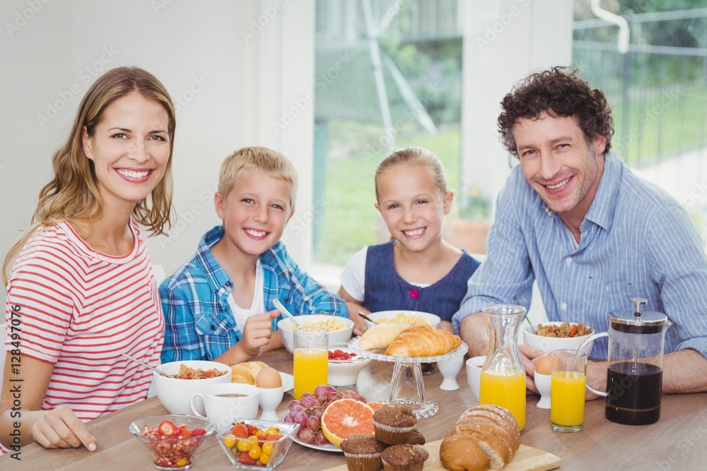 Happy family having breakfast at table Happy family having breakfast at table
