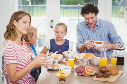 Parents having breakfast with children