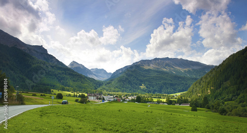 road across green meadows. Swiss