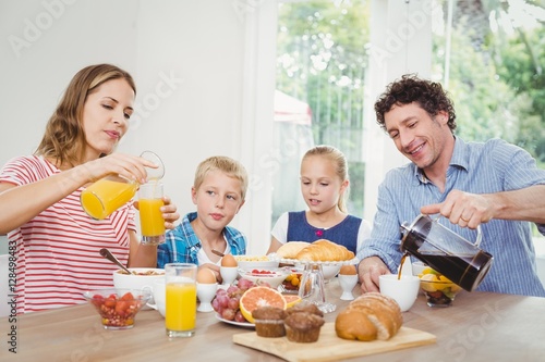 Parents having breakfast with son and daughter