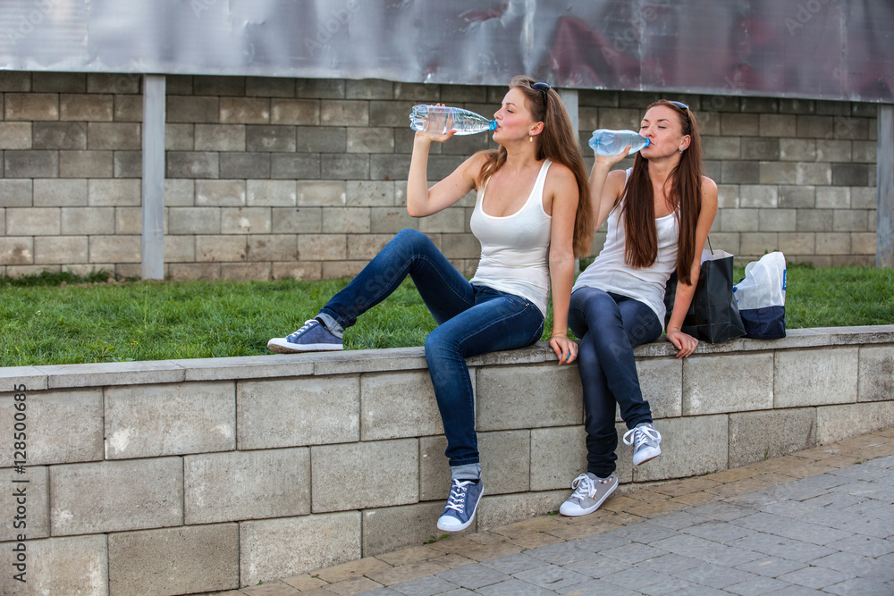 Girls drinking water a summer day