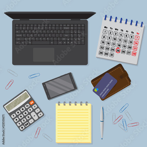 View of office desk background including laptop, digital devices, financial and business objects.