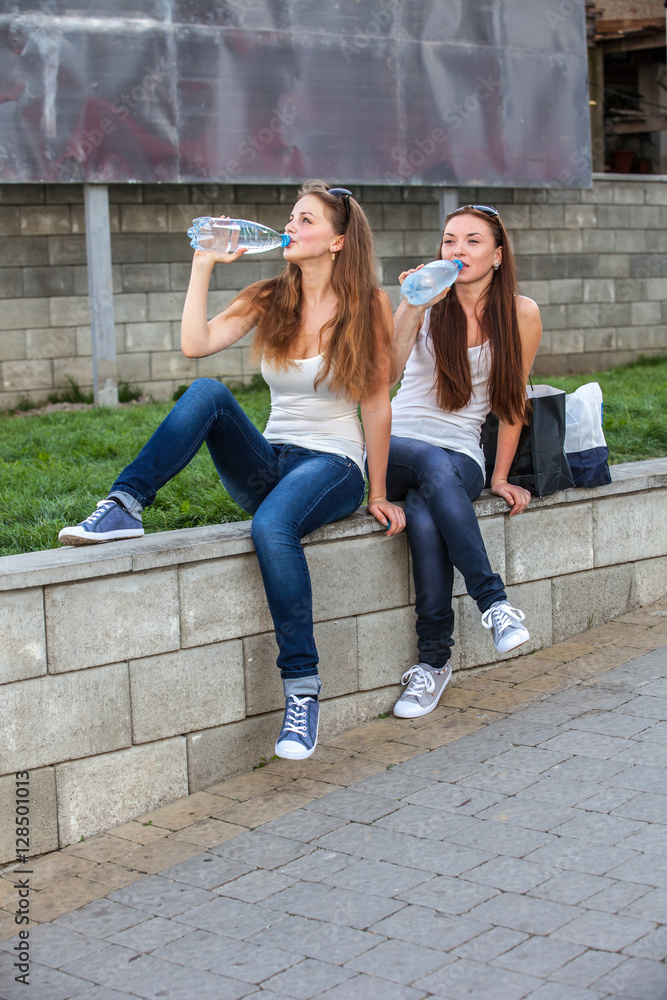 Girls drinking water a summer day