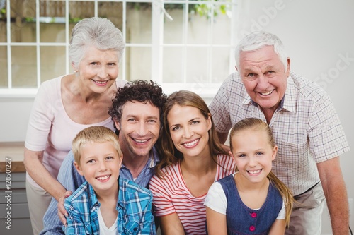 Happy multi-generation family against window at home