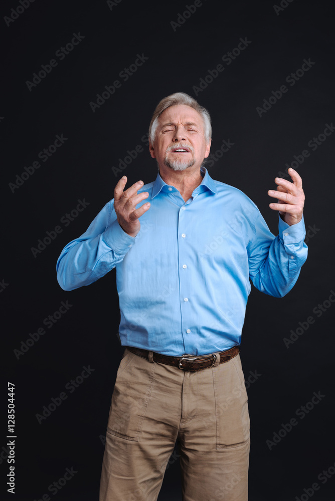 Handsome retired man keeping eyes closed Handsome retired man keeping eyes closed