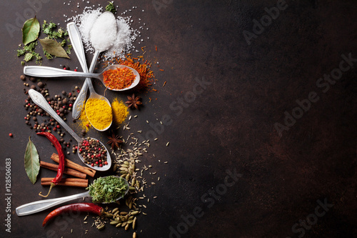 Fototapeta Naklejka Na Ścianę i Meble -  Various spices spoons on stone table