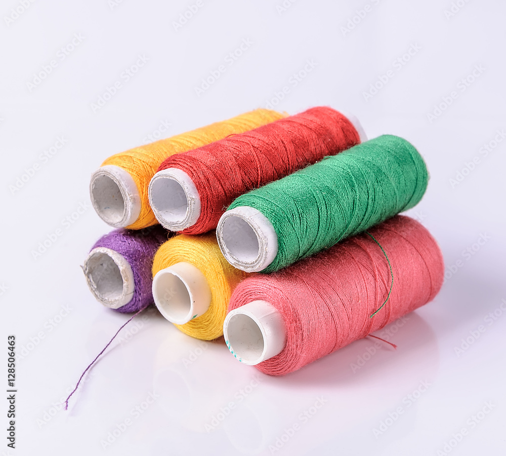 Colorful bobbin thread on white background Colorful bobbin thread on white background