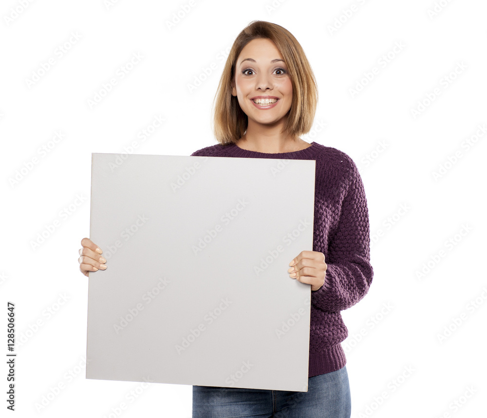 young beautiful woman in a purple sweater and jeans, holding a blank board for advertising young beautiful woman in a purple sweater and jeans, holding a blank board for advertising
