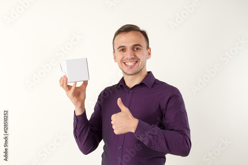 Man with small gift box. He presents it.
