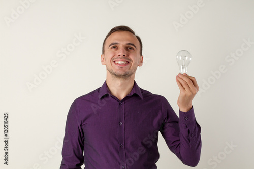 A man with a light bulb. he has an idea. Office employee.
